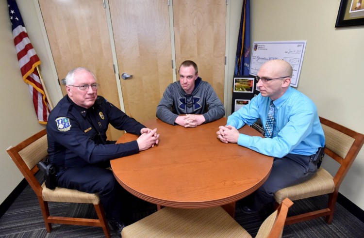 Waterville Police Chief Joseph Massey, left, talks recently with Chase Fabian, Project Hope coordinator, center, and Deputy Chief Bill Bonney about the area's opioid troubles at the Waterville police department.