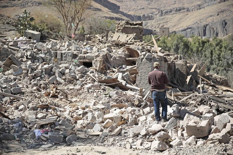 A man walks amid the rubble of a house destroyed by a Saudi-led airstrike on the outskirts of Sanaa, Yemen, in February 2017.