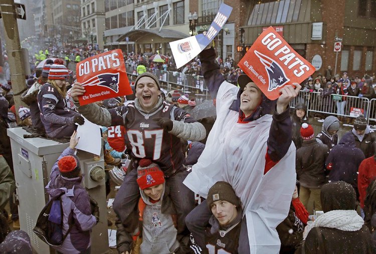 Patriots fans wait for the start of Tuesday's parade in Boston to celebrate their team's win in Super Bowl LI. If the mayors of Portland, Bangor and Brewer have their way, fans will get to celebrate with their team in Maine.