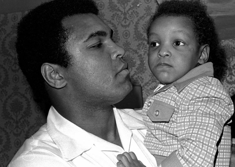 Heavyweight boxing champion Muhammad Ali, and Little Muhammad Ali, his 2 1/2 year old son, arrive at Miami Beach, Florida, in 1975. Ali's son, who bears the boxing great's name, was detained by immigration officials at a Florida airport Saturday and questioned about his ancestry and religion in what amounted to unconstitutional profiling, a family friend said.