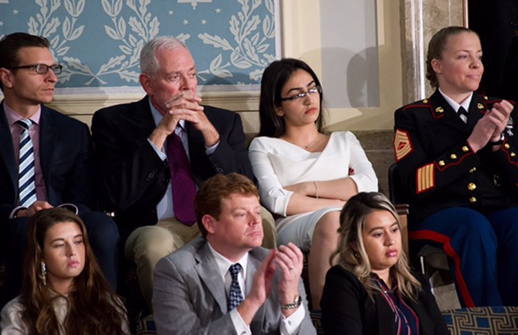 Banah Al-Hanfy, in the back row, watches President Trump give his speech to Congress on Tuesday night in the Capitol. Hours earlier, she spoke at a news conference with other guests who have been, or could be, affected by Trump’s immigration policies.