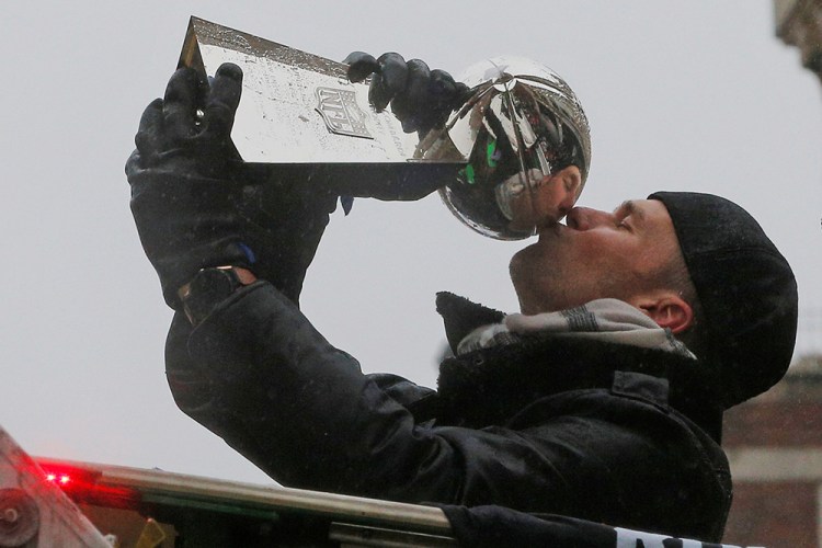 New England Patriots quarterback Tom Brady, who led the team to the greatest comeback victory in Super Bowl history, plants a kiss on the Lombardi Trophy during the team's Feb. 9 victory parade in Boston. 