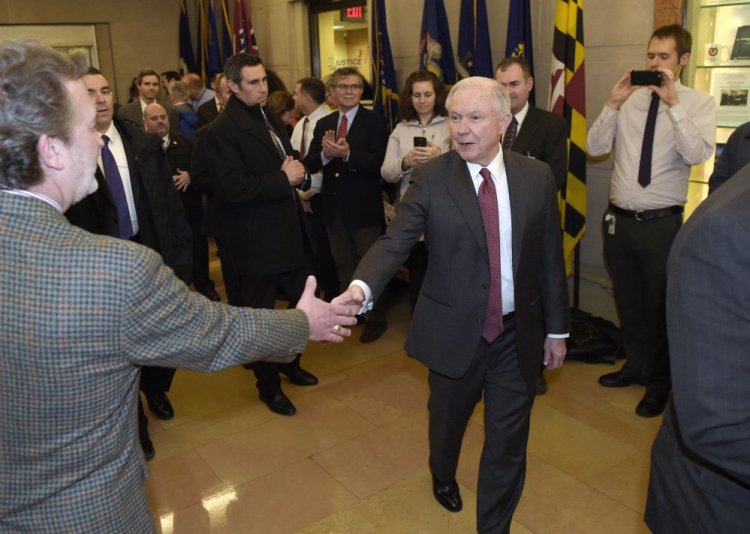 Attorney General Jeff Sessions is greeted by employees as he arrives at the Justice Department in Washington on Feb. 9. At his confirmation in January, Sessions didn't disclose that he had met twice with a Russian diplomat before the 2016 election.
