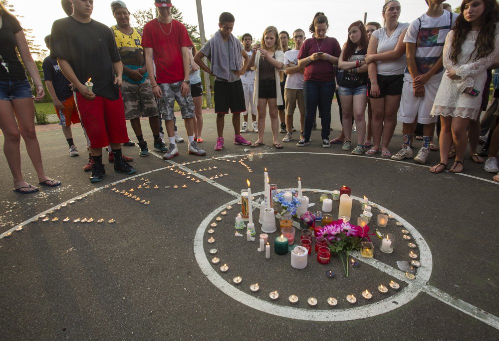 Mourners gather for a candlelight vigil for Treyjon Arsenault, 19, of Westbrook on May 26, 2015, the day after her died from a shooting in Portland.