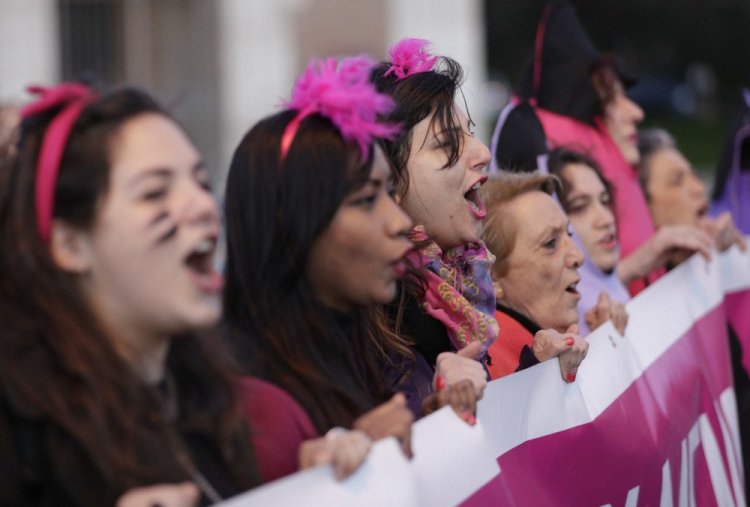 Women chant slogans as they march during a demonstration demanding equal rights for women and men, as they mark International Women's Day  in Rome on Wednesday.