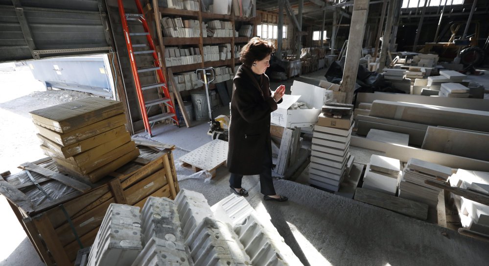 Owner Teresa Van Vleet-Danos walks through the production area in the Rowat Cut Stone & Marble plant in Des Moines, Iowa. "I love this old building," she said, but it will be torn down this summer and replaced with apartment towers.