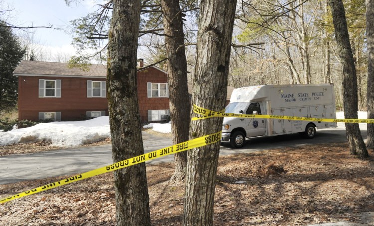 A Maine State Police van is parked Thursday outside the home of Matthew and Sue Kim Coito on Campground Road in Arundel. His body was found Wednesday in the kitchen. Hers was found Friday about 375 yards into the woods near the home.