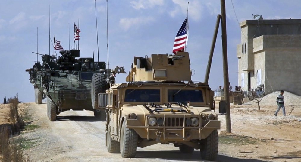 U.S. forces patrol on the outskirts of the Syrian town of Manbij. U.S. troops will provide artillery fire in the battle for the Islamic State group's de facto capital, Raqqa.