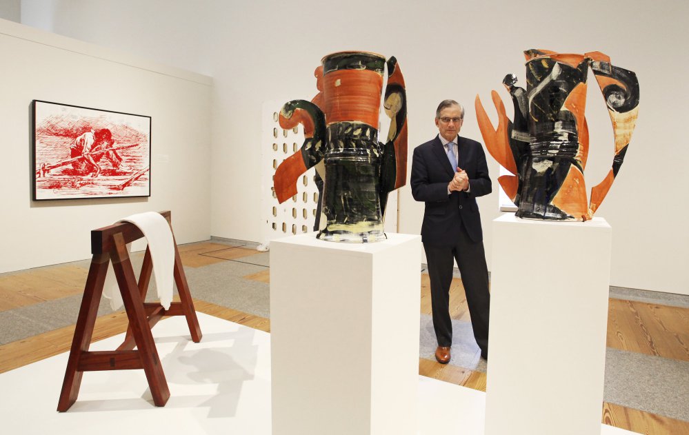 William "Bro" Adams, the National Endowment for the Humanities chairman, studies glazed earthenware sculptures while touring the Portland Museum of Art on Friday. The museum closed for a month in January to make improvements.