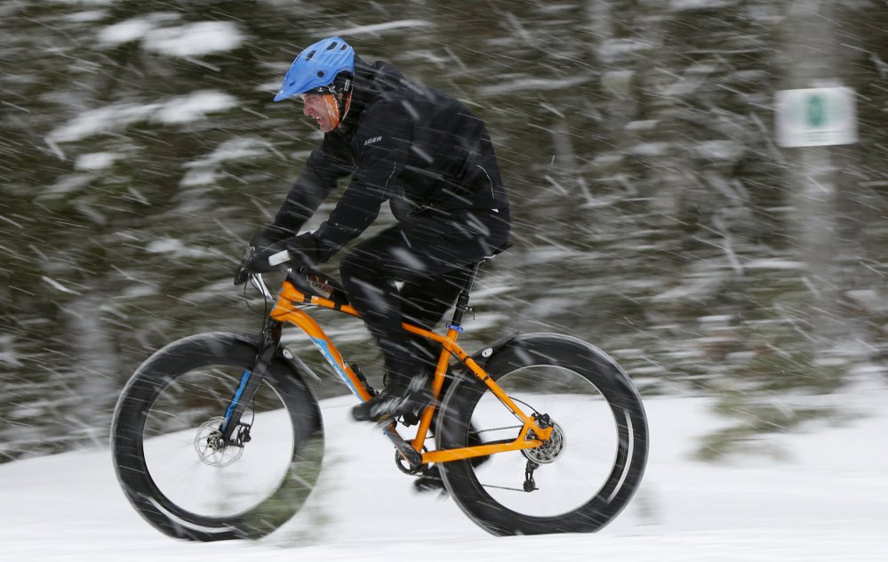 A fat tire bicyclist rides on a cross country ski trail during a race at the Sugarloaf ski resort in Carrabassett Valley. The mountain bikes with comically large tires have been around for a decade, but they've come into the mainstream in the past five years. Research firm The NPD Group says sales have grown eightfold over the past three years.