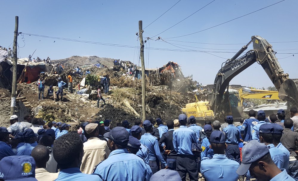 Police secure the perimeter at the scene of a garbage landslide, as excavators aid rescue efforts, on the outskirts of the capital, Addis Ababa, Ethiopia, on Sunday. 