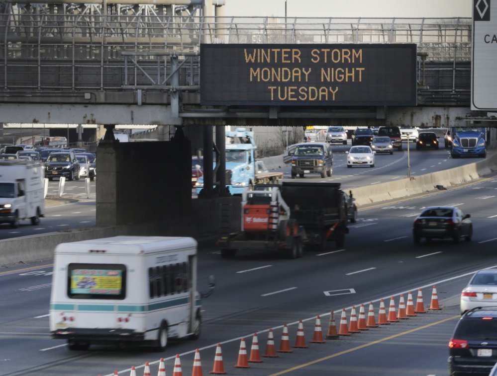 A sign warns motorists about an impending winter storm in Fort Lee, N.J., on Monday. The Northeast is bracing for a blizzard expected to sweep the New York region with possibly the season's biggest snowstorm.