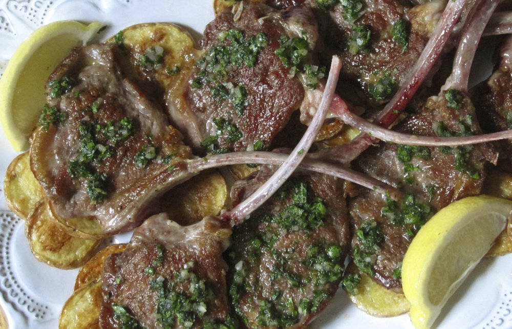 Seared lamb chops with mint herb sauce.