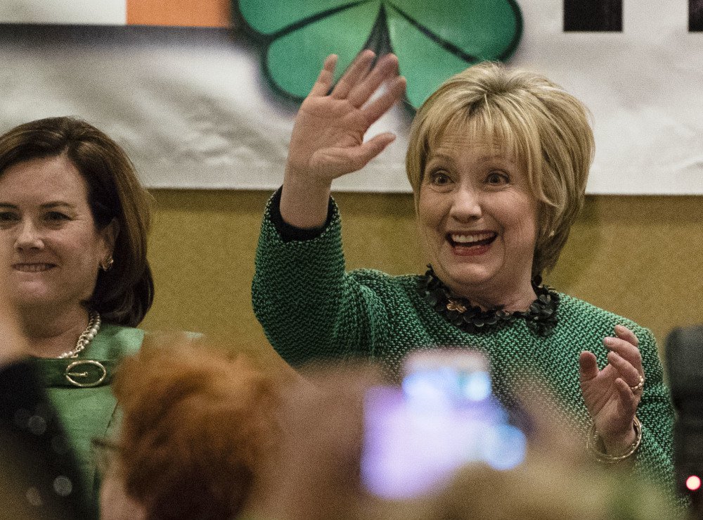 Hillary Clinton waves as she arrives at a St. Patrick's Day in her late father's hometown in Scranton, Pa., on Friday. Clinton said she was having a hard time watching the news.