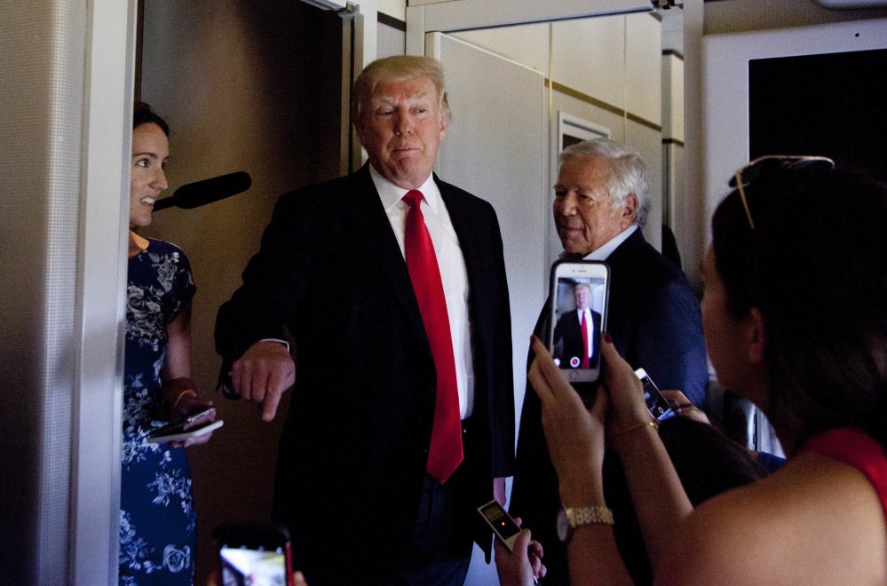 President Trump, shown speaking to the media aboard Air Force One in Palm Beach, Fla., on Sunday, has not backed down from his wiretapping allegation. Standing beside Trump is New England Patriots owner Robert Kraft. The two are known to be close friends. Kraft was also seen following Trump into the White House shortly before 7 p.m., The Boston Globe reported.
