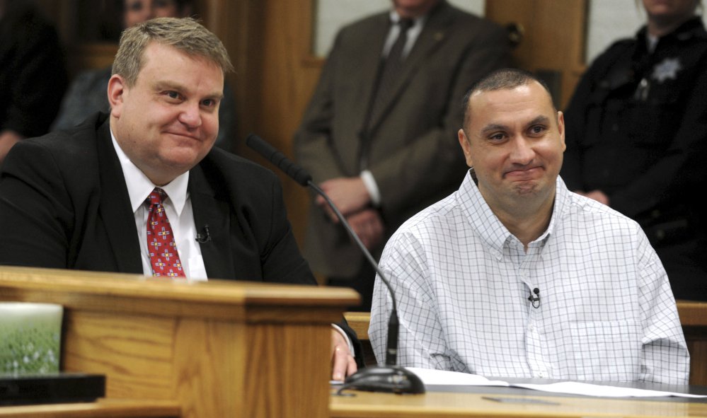 Christopher Tapp, right, and public defender John Thomas smile during Tapp's post conviction relief hearing at Bonneville Courthouse in Idaho Falls, Idaho, Wednesday.