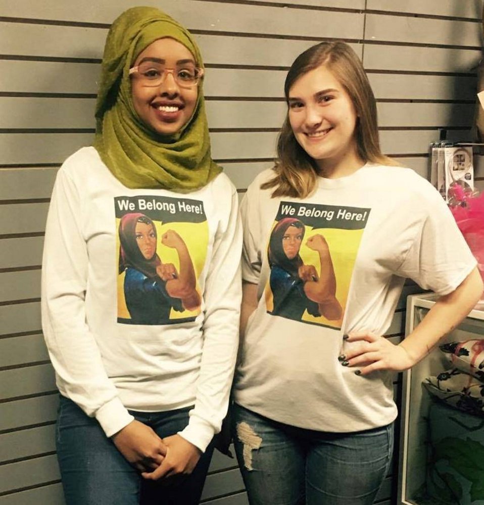 Portland High School senior Zahra Abukar, left, and Windham High School senior Taylor Rickett show off the T-shirts.