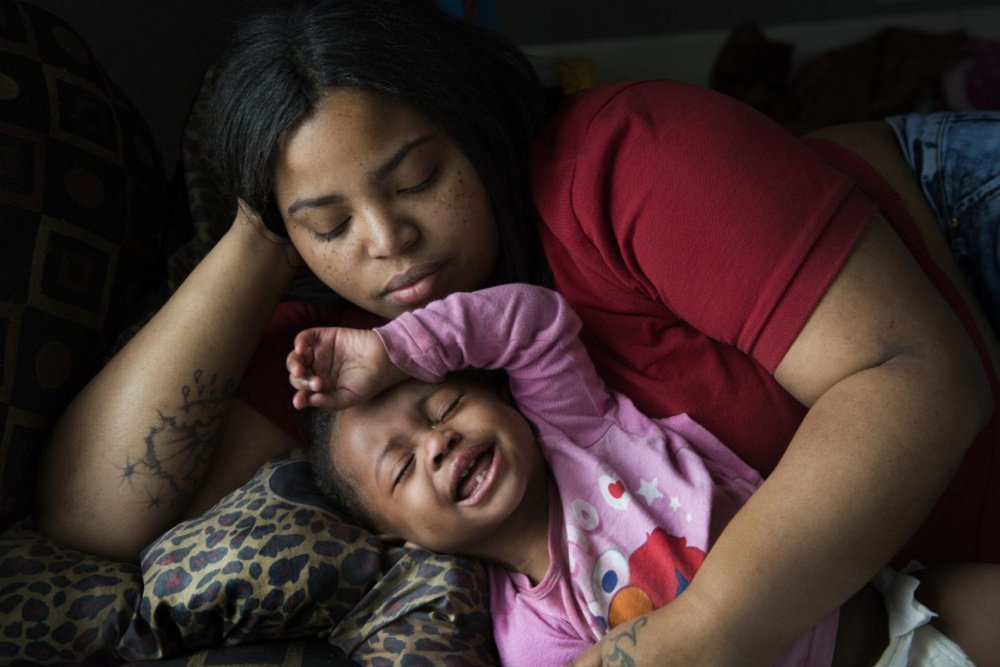 Nakeyja Cade with her year-old daughter Zariyah Cade in Flint, Mich., last March. The girl's blood had tested high for lead. A new study shows children with elevated blood-lead levels at age 11 ended up as adults with lower cognitive function than their parents.
