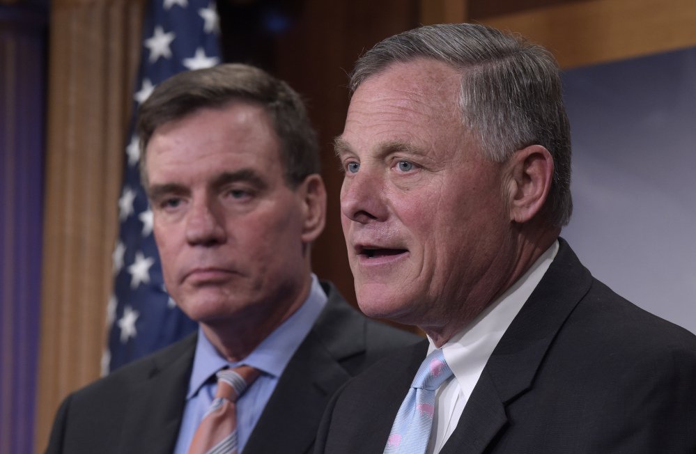 Senate Intelligence Committee Chairman Richard Burr, R-N.C., right, and committee Vice Chairman Mark Warner, D-Va., hold a rare joint news conference to offer an update on the Russia meddling probe.