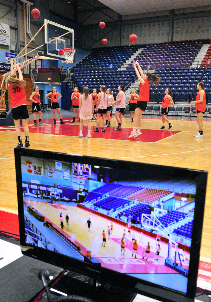 The Brunswick Dragons are seen on the Maine Public television monitor as they practice on Thursday at the Augusta Civic Center.