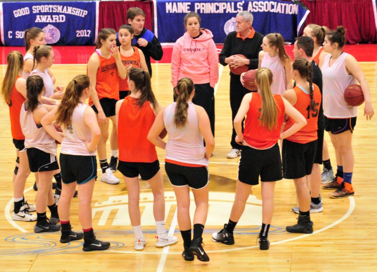 The Brunswick Dragons talk at midcourt during practice Thursday at the Augusta Civic Center.