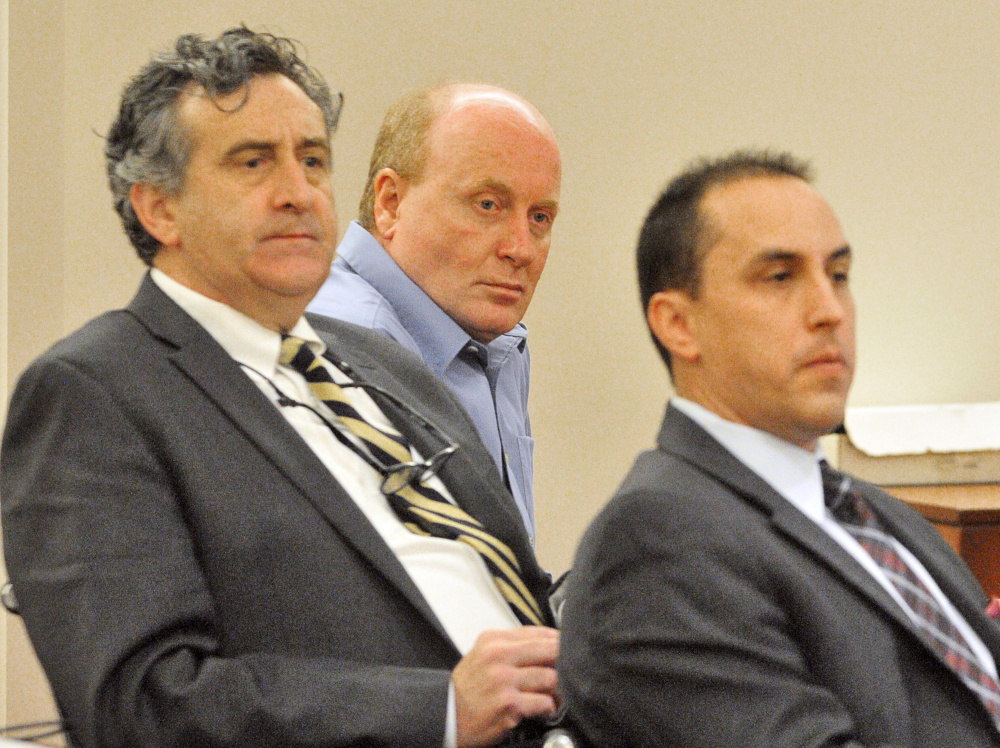 Roland L. Cummings, center, is flanked by his defense attorneys, Ronald Bourget, left, and Darrick Banda, on Nov. 12, 2015, during his trial at the Capital Judicial Center in Augusta.