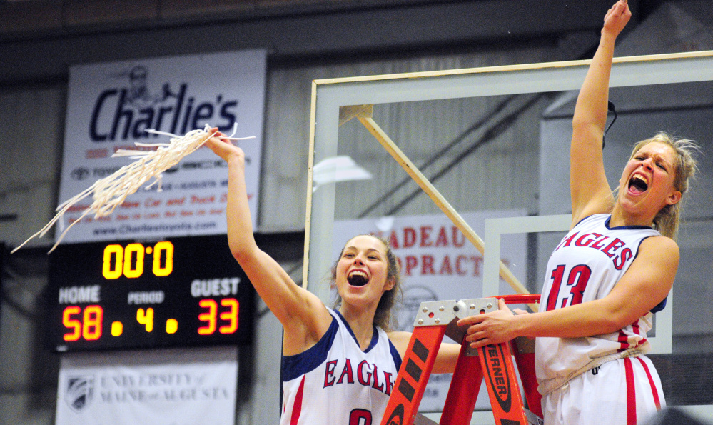 Messalonskee's Sophie Holmes, left, and Lydia Dexter celebrate after cutting down nets after defeating Brunswick in the Class A state final Saturday at the Augusta Civic Center.