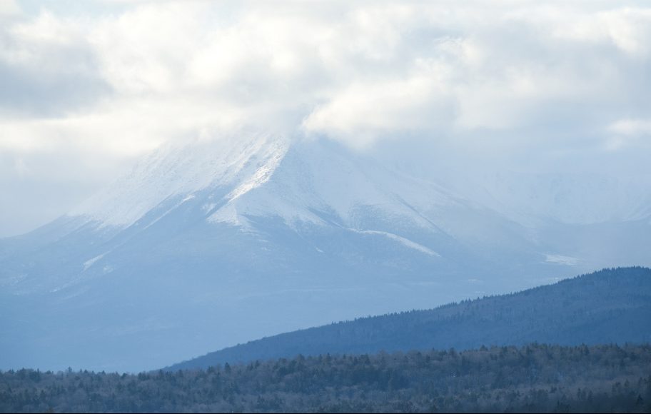 Snow and clouds obscure the peak of Mt. Katahdin, as seen from Patten. Mt Katahdin sits within Baxter State Park, which borders the Katahdin Woods and Waters National Monument.