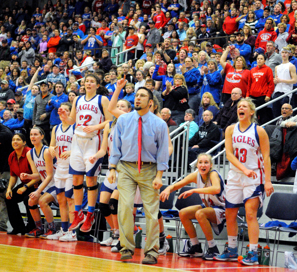Messalonskee's bench and fans celebrate a basket in the final minutes against Brunswick in the Class A state championship Saturday at the Augusta Civic Center.