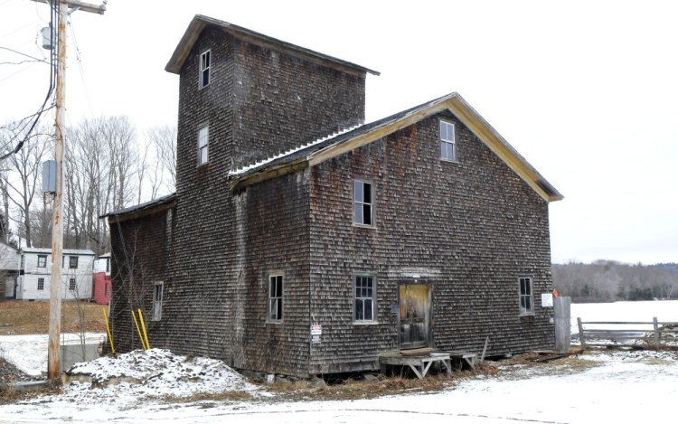 The mill on Branch Mills Road in South China, seen Tuesday, is being dismantled. When the job is finished, the site is expected to be purchased by the Atlantic Salmon Federation.