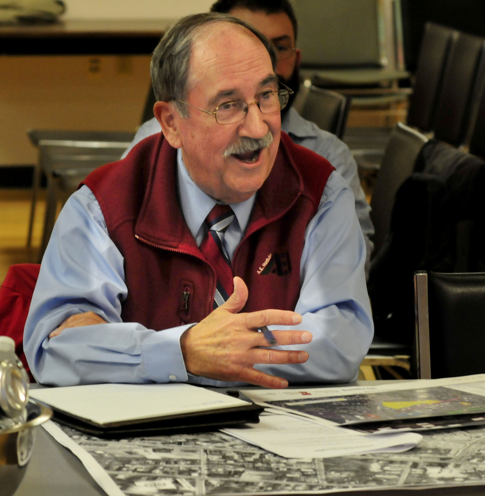 Al Hodsdon, owner oif A.E. Hodsdon Engineers, sits beside maps and photos of Waterville while speaking Wednesday evening to other members of the Waterville Parking Study Committee during its inaugural meeting.