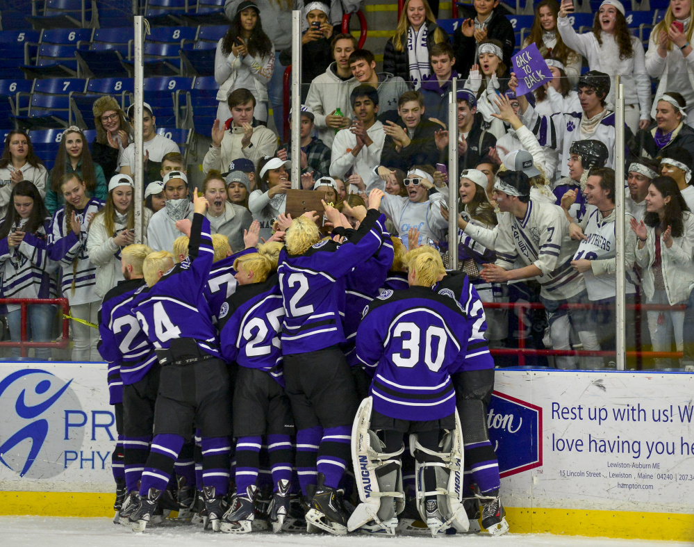 Members of the Waterville hockey team celebrate in front of student supporters after the Panthers upended York 7-4 in the Class B state championship game Saturday in Lewiston.