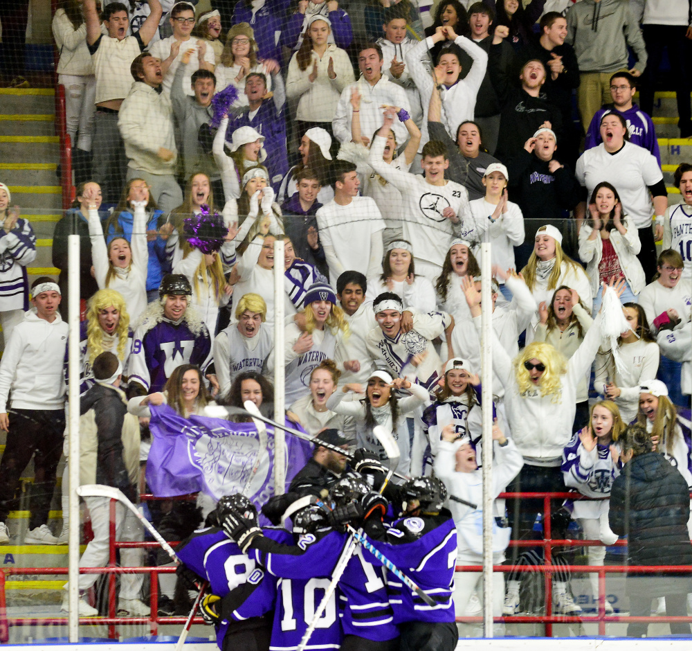 The Waterville hockey team and its fans celebrate a late goal during the Class B state championship game against York on Saturday in Lewiston.