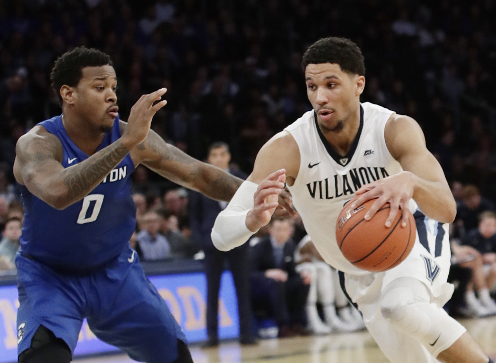 Villanova's Josh Hart (3) drives past Creighton's Marcus Foster (0) during the first half of the Big East championship game Saturday in New York.