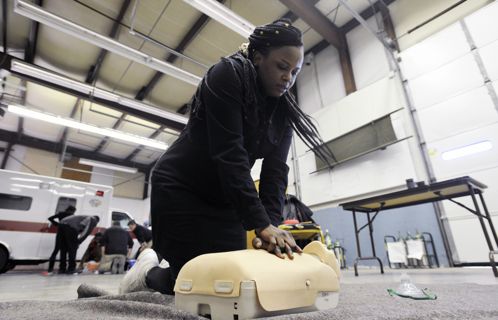 Jolly Ntirumenyerwa of Portland, originally from the Democratic Republic of Congo, performs CPR on a training mannequin at SMCC. Ntirumenyerwa is taking part in a new program at SMCC that focuses on training immigrants to become EMTs.