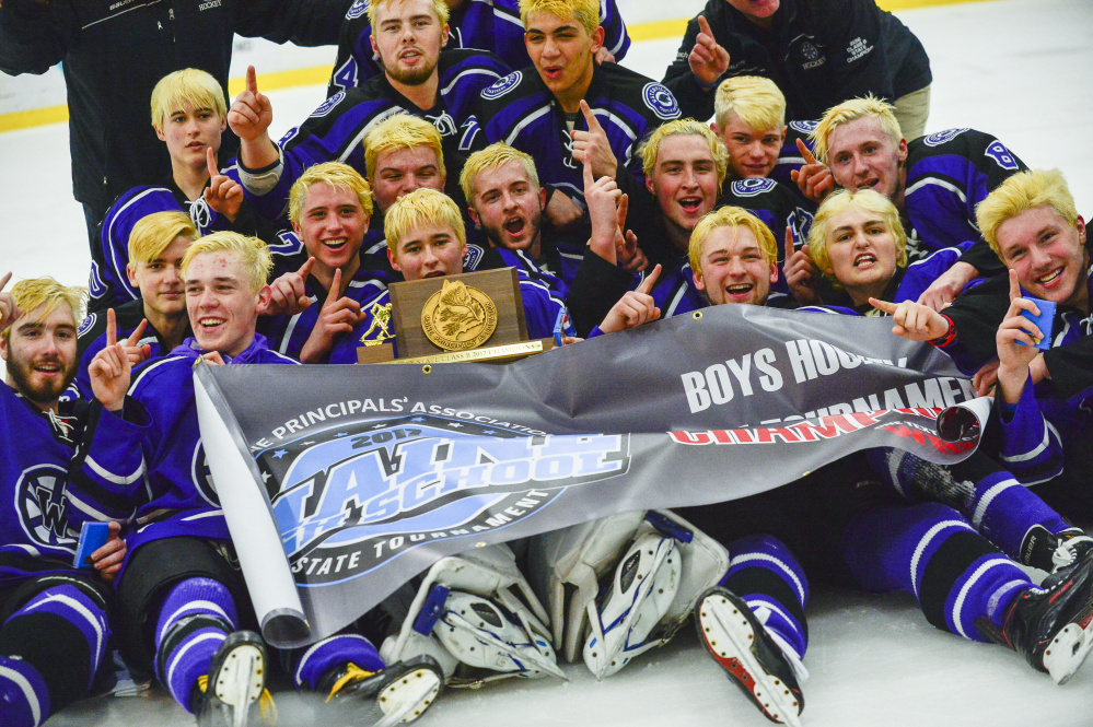The Waterville hockey team celebrates after their 7-4 victory over York in the Class B state title game Saturday at the Androscoggin Bank Colisee in Lewiston.