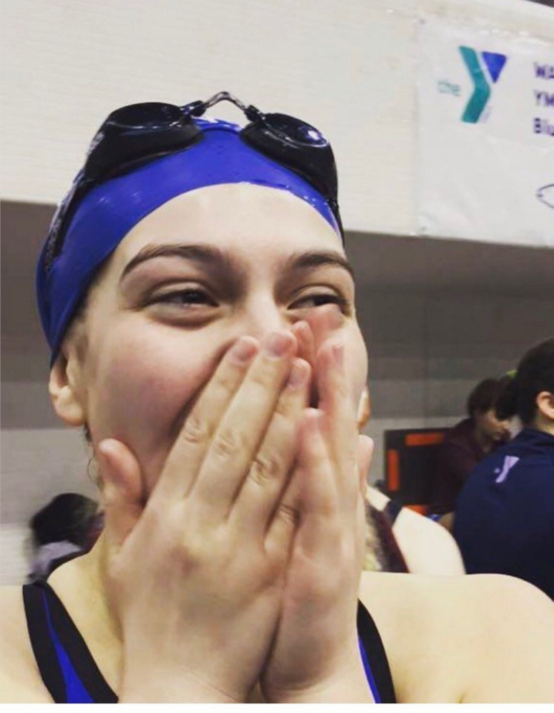 Mid-Maine Dolphins swim team member Mackenzie Burton reacts during a state championship earlier this month in Orono.