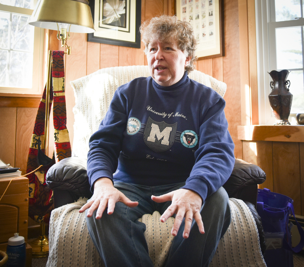 Elaine Briggs, of Wayne, seen Sunday at her home, shows off one of the many items she has knitted. While she is still working, she hopes to retire and stay in her home in Wayne. A prolific knitter, she knits a variety of items for family and friends, as well as local charities.