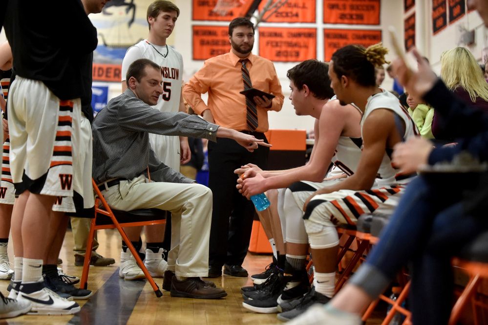 Winslow boys basketball coach Jared Browne talks to his team in a timeout during a Kennebec Valley Athletic Conference game against Erskine this past season.