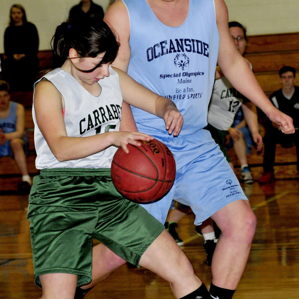 Carrabec/Madison's Kaitlin Dixon tries to get around Oceanside defender  Zachary Gledhill during a unified basketball North quarterfinal Wednesday afternoon in North Anson.