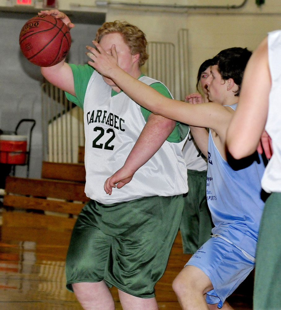 Carrabec's Dalton Way tries to get past an Oceanside defender during a unified basketball North quarterfinal Wednesday afternoon in North Anson.