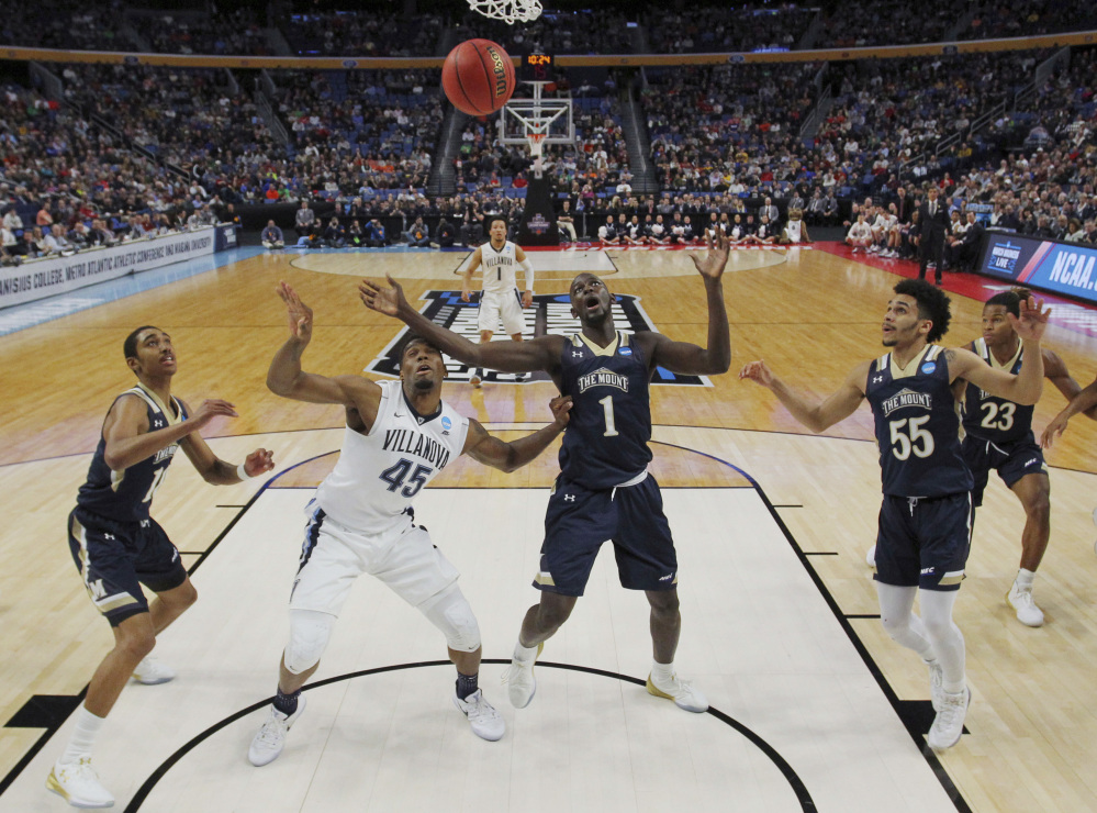 AP photo 
 Villanova forward Darryl Reynolds (45) and Mount St. Mary's center Mawdo Sallah (1) battle for a rebound during the first half of a first-round game Thursday in the NCAA Tournament in Buffalo, N.Y.
