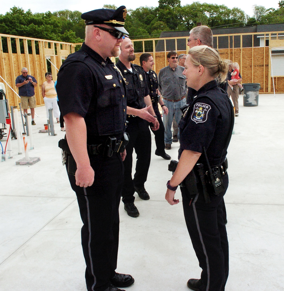 Oakland police Staff Sgt. Peter Tibbetts takes part in an inspection of police officers, including Officer Tanya Allen, during a town swearing-in ceremony May 25, 2016, at the town's new police station. Oakland officers voted Friday to unionize with the Maine Association of Police.