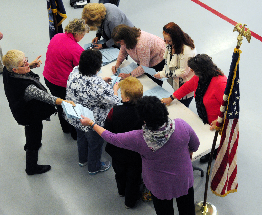 Officials sort and count ballots from morning voting Saturday in West Gardiner's fire station before the West Gardiner Town Meeting.