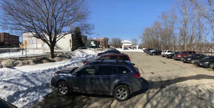 City officials are considering leasing public parking spaces off Front Street to Colby College for the 42-room boutique hotel the college plans to build, top left, at the site of the now-demolished Levine's building.