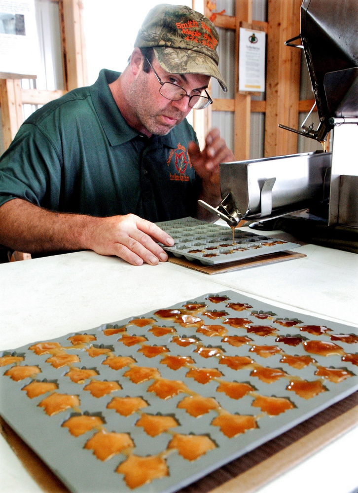 SKOWHEGAN,  ME-  August 14: James Smith lll of Smith Brothers Maple in Skowhegan fills trays with maple syrup to make maple candy inside the new Maple House exhibit building at the Skowhegan Fairgrounds on Sunday, August 14, 2016.  (Photo by David Leaming/Staff Photographer)