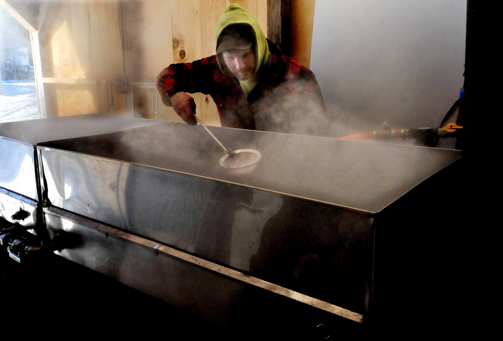 SKOWHEGAN,  ME0  March 3: Jason Tessier scoops off foam as maple sap boils down into maple syrup at his farm in Skowhegan on Thursday, March 3, 2016.  Tessier said this is the first time boiling this season and said it is still early and he expects conditions to improve soon. (Photo by David Leaming/Staff Photographer)