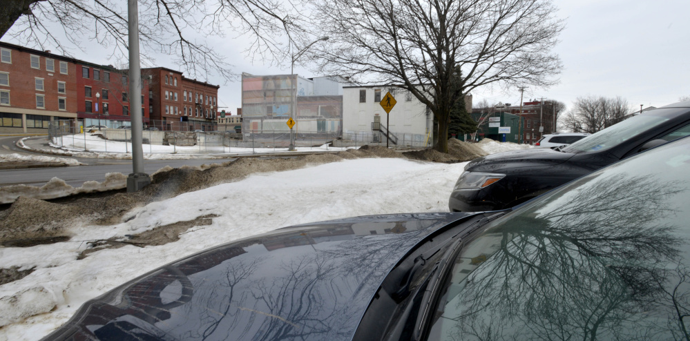Cars line a city-owned parking lot Tuesday off Front Street, across the street from the site of a planned boutique hotel.