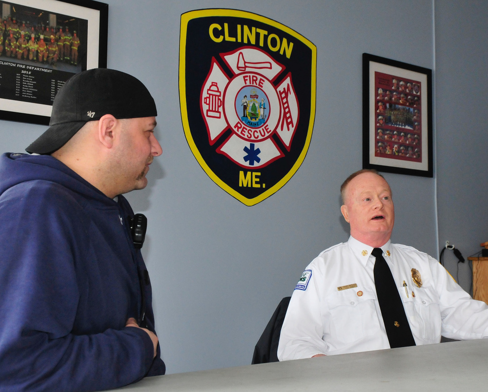 Retiring Clinton Fire Chief Gary Petley, right, speaks Wednesday about his long career as a firefighter, the last 25 years of which he was the fire chief. At left is firefighter Travis Fillmore.