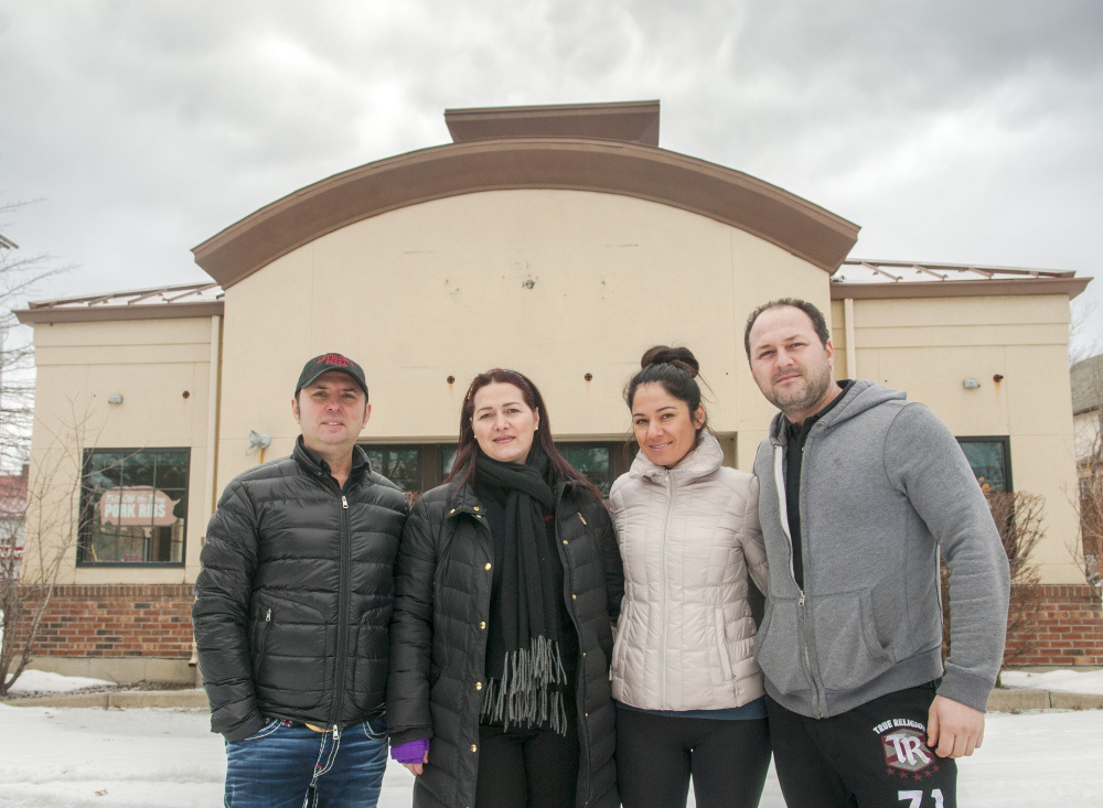 From left, Kastroit Xhollo, Antigoni Papagjaki, Ermira Martiko and Ervin Papagjaki stand on Wednesday outside a former Pizza Hut, a location that they are planning to turn into Antigoni's Augusta, on Bangor Street in Augusta.